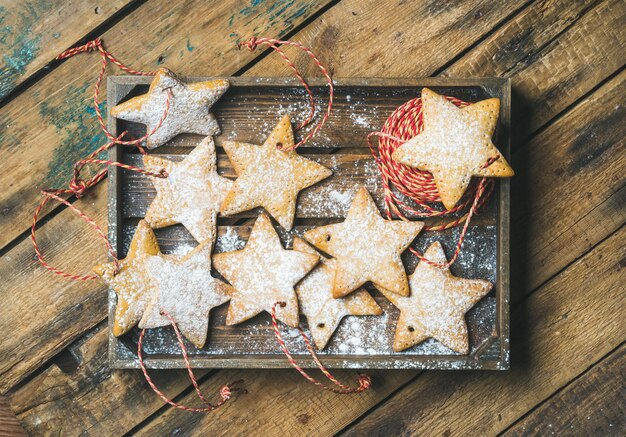 Christmas gingerbread cookies with sugar powder and decoration rope