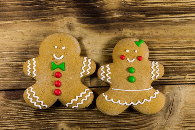 Christmas gingerbread couple cookies on wooden table. Top view