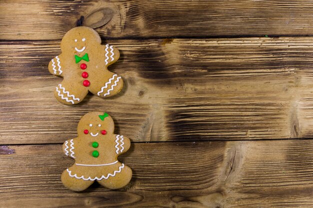 Christmas gingerbread couple cookies on wooden table. Top view