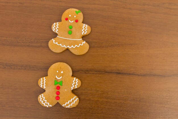 Christmas gingerbread couple cookies on wooden table. Top view