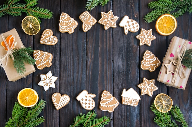 Christmas gingerbread of different kinds on a black and white wooden background