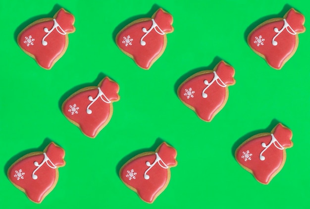 Christmas gingerbread in the shape of gift bag on the green background Flat lay