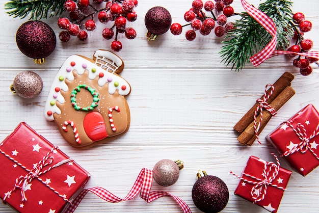 christmas gingerbread with christmas decorations on white wooden table. christmas holiday background