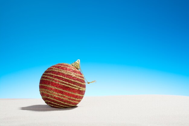 Christmas glass ball on the beach