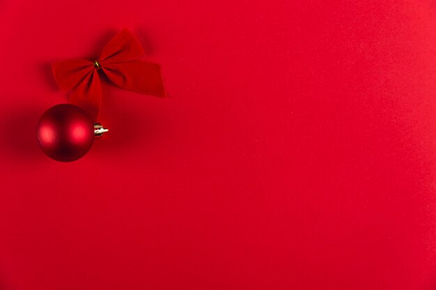 Christmas glass ball and bow on a red , Christmas , copyspace.