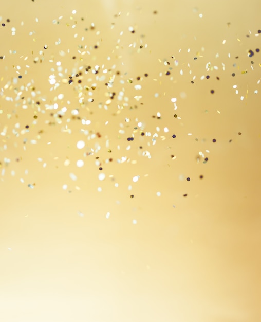 Photo christmas gold background. golden holiday glowing abstract glitter defocused background