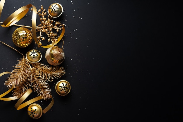 Christmas golden baubles on dark background. Flat Lay.