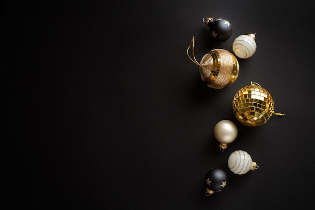 Christmas golden baubles on dark surface