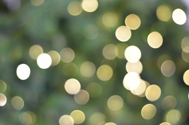 Christmas golden and green lights. Background of bright bokeh.