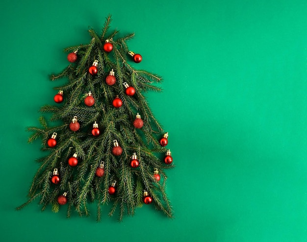 Christmas green background pine branches needles and christmas\
trees view from above round frame with place for text christmas\
nature background december mood concept copy space