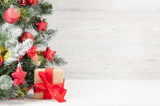 christmas greeting card with decorated xmas fir tree gift box and space for your greetings