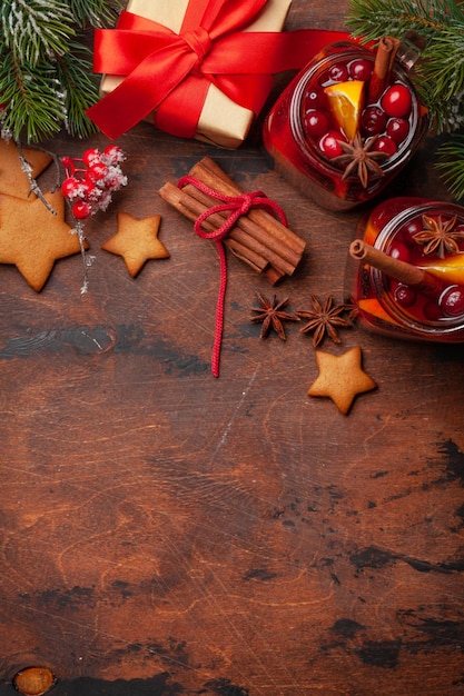 Christmas greeting card with mulled wine gingerbread cookies gift box and xmas tree Top view flat lay with space for your greetings