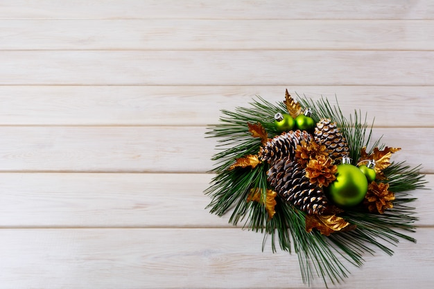 Christmas greeting with pine branches and golden cones