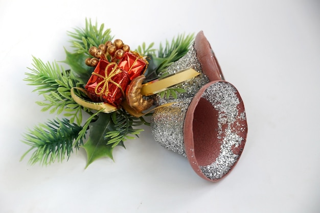 Christmas hand bells in the form of door ornament with greens