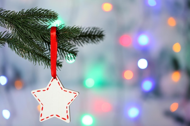 Christmas handmade decorations hanging on Christmas tree on blurred background