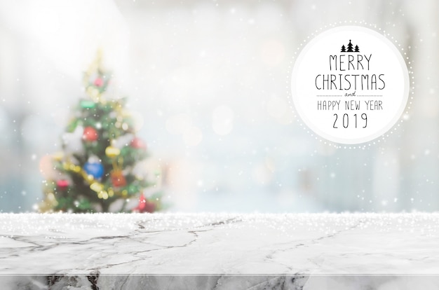 Christmas and Happy new year 2019 on empty white marble stone table top on blur bokeh chri