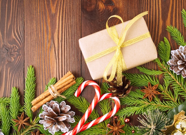 Christmas and Happy New Year background. Gift Christmas box of Kraft paper, wooden table.