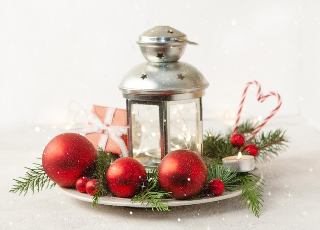 Christmas and Happy New Year composition with Lantern, candles, fir tree and  red balls festive decoration