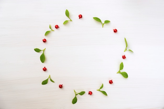 Christmas and Happy new year composition. Wreath from green leaf and red ball 