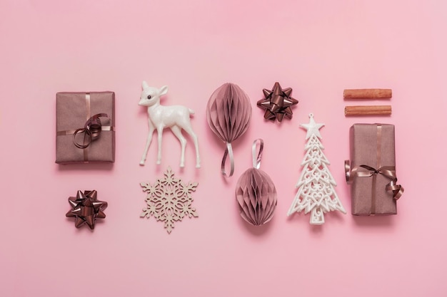 Christmas and Happy new year flat lay composition for greeting card on pink background Xmas decorations and gifts top view