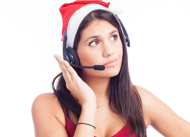 Christmas headset woman from telemarketing call center wearing red santa hat talking smiling isolated on white background