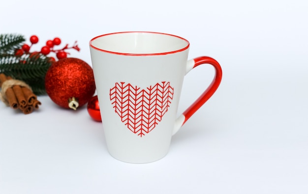 Christmas holiday background with checked cup and decorations on white background. Flat lay with copy space