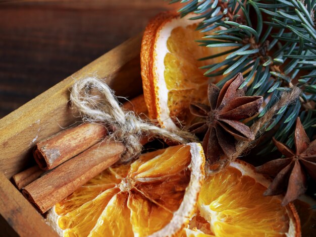 Christmas holiday composition with branches and dry Oranges with Cinnamon sticks