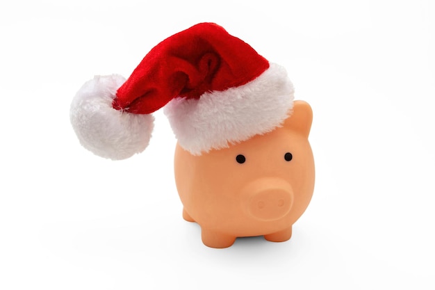 Christmas holiday cost and savings Piggy bank with Santa hat isolated on white