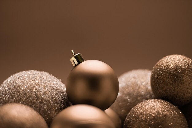 Christmas holiday and festive decoration concept golden baubles on beige background