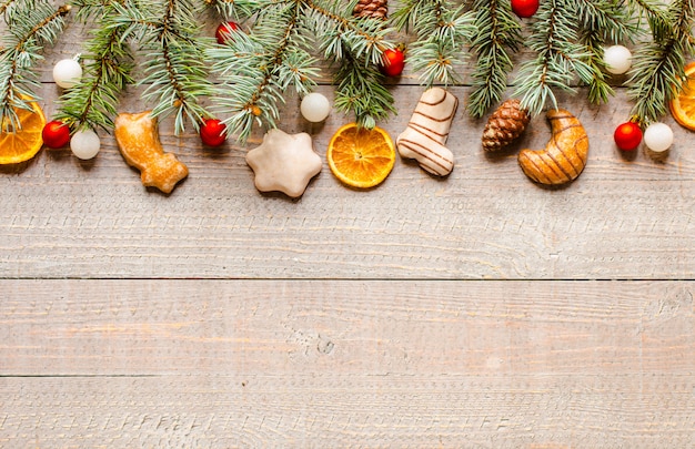Christmas holiday surface with ornaments on rustic wooden surface.