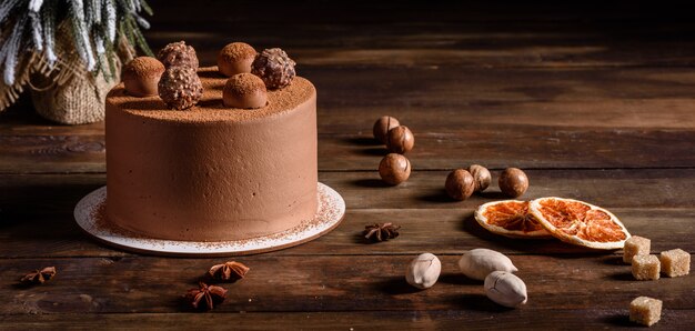 Christmas holiday table with delicious truffle cake and beautiful gingerbreads