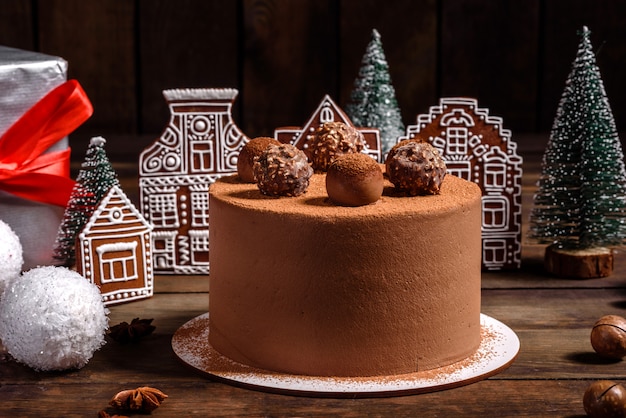 Christmas holiday table with delicious truffle cake and beautiful gingerbreads