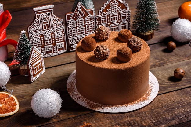 Christmas holiday table with delicious truffle cake and beautiful gingerbreads