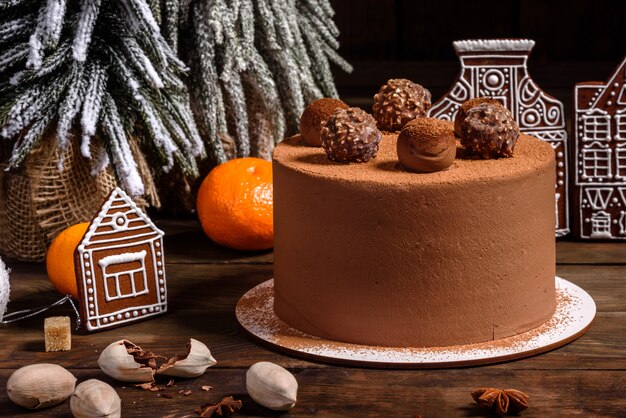 Christmas holiday table with delicious truffle cake and beautiful gingerbreads