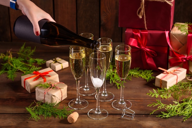 Christmas holiday table with glasses and a bottle and gifts