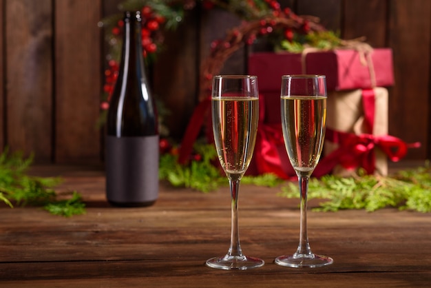 Christmas holiday table with glasses and a bottle and gifts