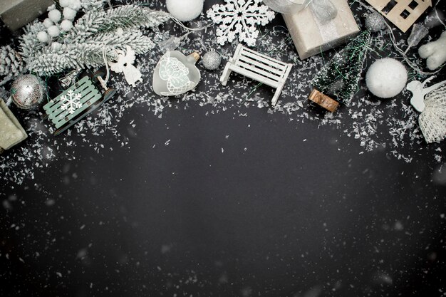 Christmas holiday toys and snow the space for text. New Year concept. Black background. To