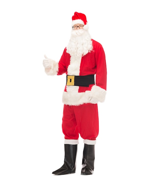 christmas, holidays, gesture and people concept- man in costume of santa claus showing thumbs up