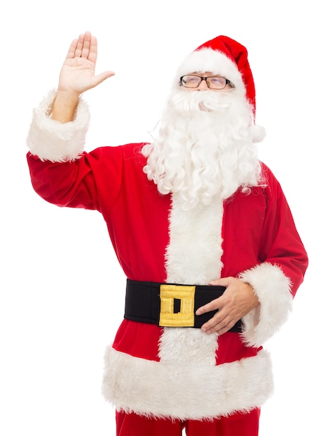 christmas, holidays, gesture and people concept - man in costume of santa claus waving hand