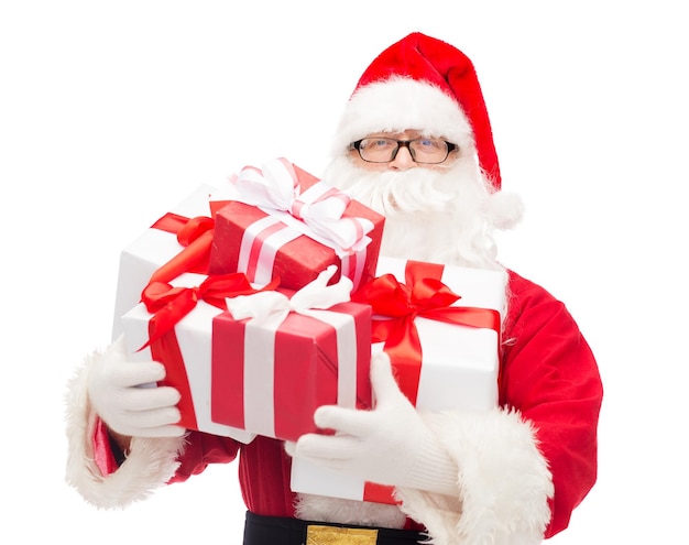 christmas, holidays and people concept - man in costume of santa claus with gift boxes