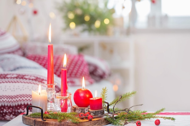 Christmas home decorations with candles in red and white colors