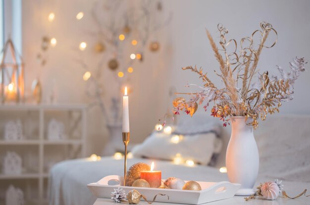 christmas home decorations with candles in white interior