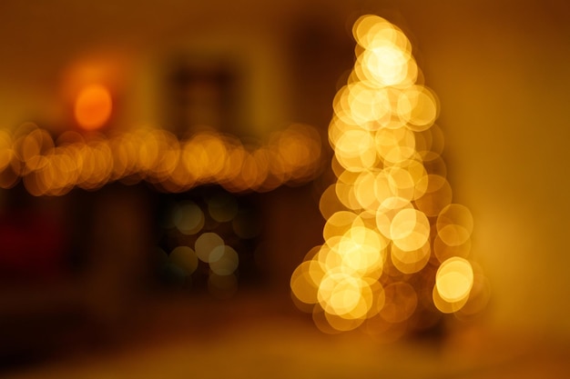 Christmas home interior with christmas tree and festive bokeh lighting blurred holiday background