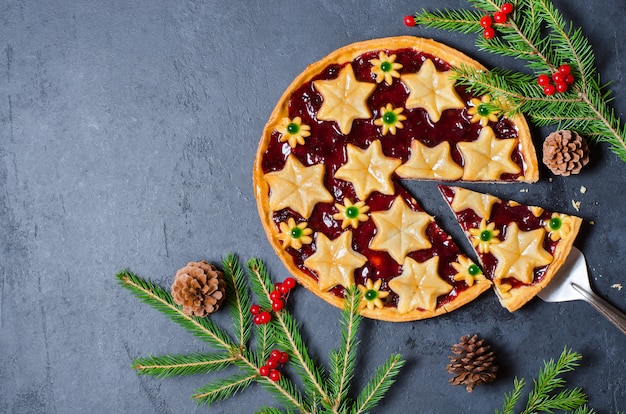 Christmas home sweet cake with jam on dark background 