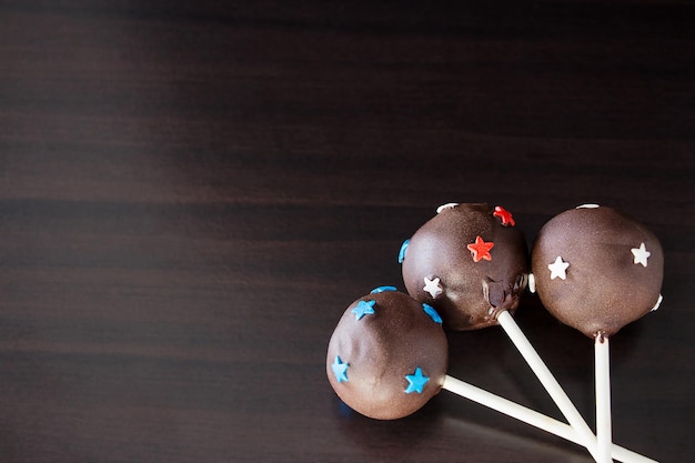 Christmas Homemade Chocolate cake pops on sticks Dark wooden background Copy space