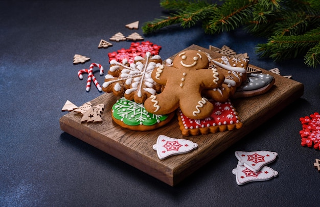 Christmas homemade gingerbread cookies on a dark concrete table table