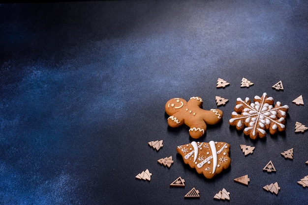 Christmas homemade gingerbread cookies on a dark concrete table