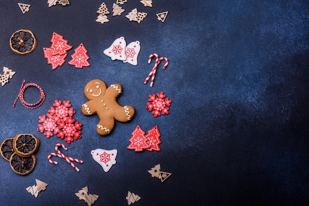 Christmas homemade gingerbread cookies on a dark concrete table