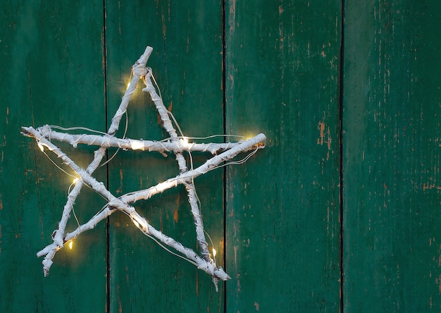 christmas homemade twig star on rustic green wooden background