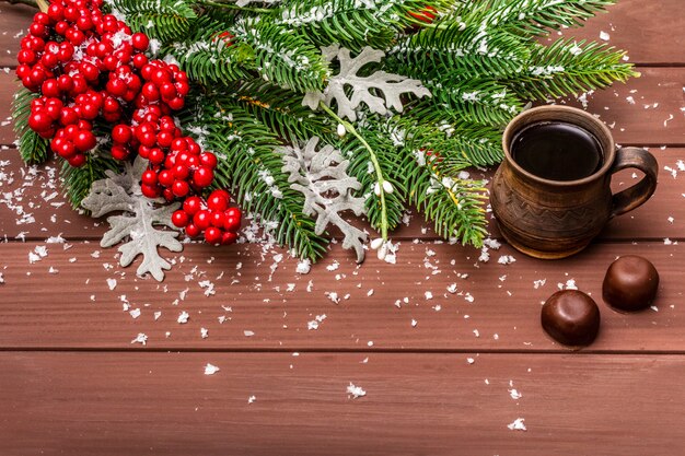 クリスマスホットコーヒー、モミの木、新鮮な葉、チョコレート菓子、人工雪。